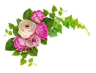 Pink roses and ranunculus flowers with ivy green leaves in a corner arrangement