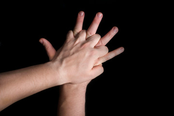 position of hands in an indirect heart massage on a black background