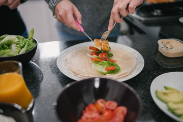 Close up of woman making healthy wraps