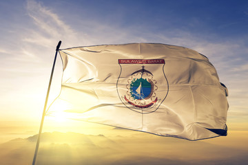 West Sulawesi province of Indonesia flag waving on the top sunrise mist fog