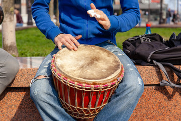 Fototapeta na wymiar street musician plays bongo