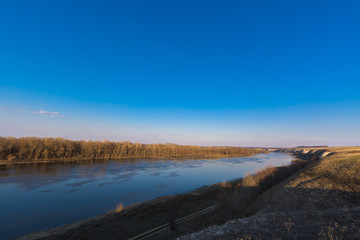 panorama of the river. wide channel, blue sky. mountain shore