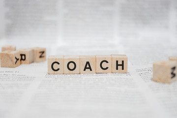 Coach Word Written In Wooden Cube - Newspaper
