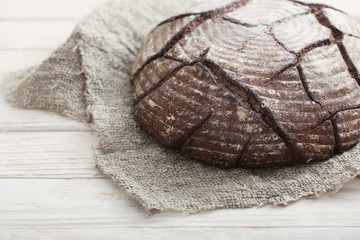 Fototapeta na wymiar homemade bread on white wooden background