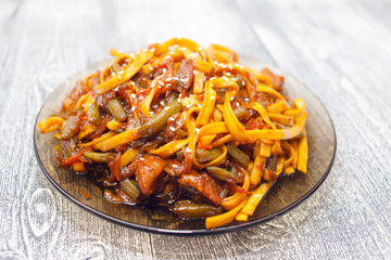 Udon noodles with vegetables and pork. Teriyaki sauce. white plate Asian cuisine