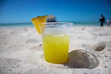 Beautiful orange cocktail on a tropical beach on a sunny day.