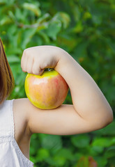 Child with an apple. Selective focus. nature