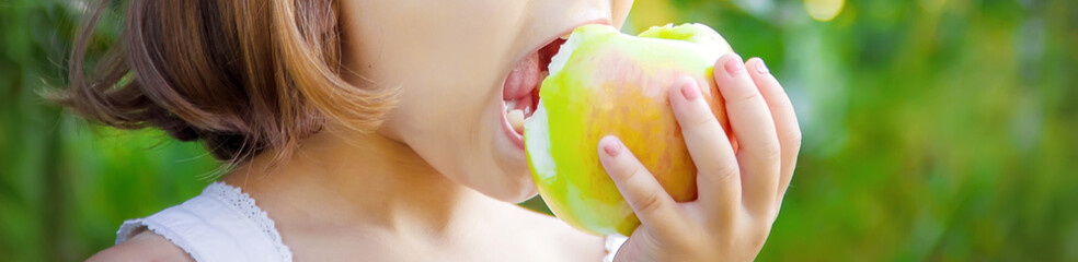 Child with an apple. Selective focus. nature