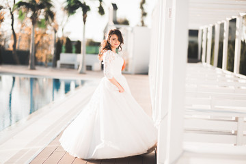 Beautiful bride spinning with perfect dress in the park