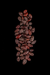 Roasted beans. Cocoa beans and coffee beans isolated on black background.