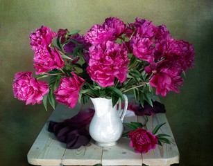 Still life with pink peonies isolated on brown background.