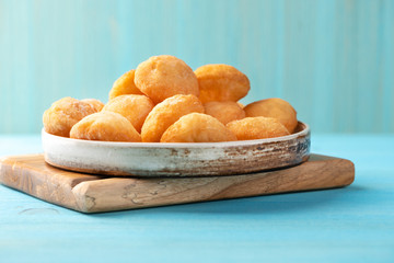 Baursak - traditional Kazakh (Asia) food \ national bread in plate on blue wooden background, top view