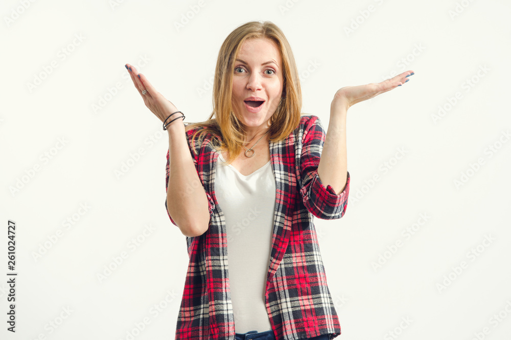 Canvas Prints Surprised beautiful woman raised her hands up standing on a light background.