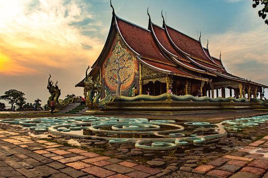 Thailand - Ubon Ratchathani: 10 April 2019: Thai people take family to visit Sirindhorn Wararam Phupha Temple (Wat Phu Phrao) in the evening near a very beautiful temple.