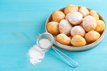 Baursak - traditional Kazakh (Asia) food \ national bread in plate on blue wooden background, top view