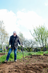 Man preparing ground to grow own vegetables in an allotment garden