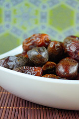 sweet algerian arabic dates fruits on a white plate