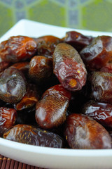 sweet algerian arabic dates fruits on a white plate