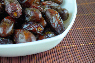 sweet algerian arabic dates fruits on a white plate