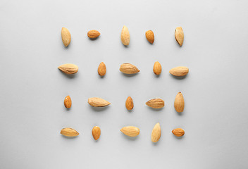 Tasty almonds on grey background