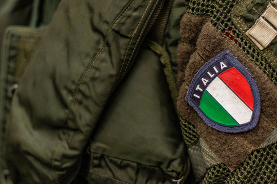 Italian military uniform details. Close up shot of the national logo on dark green suit.