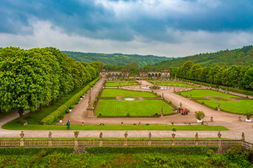 Great aerial view of the beautiful Baroque garden of Weikersheim Palace at the Tauber valley, framed by chestnut-lined avenues with the Hercules Fountain in the middle and the orangery in the back.