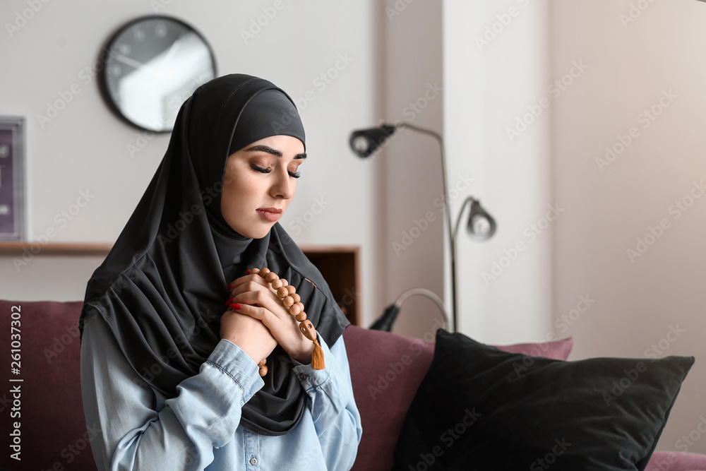 Wall mural muslim woman with tasbih at home