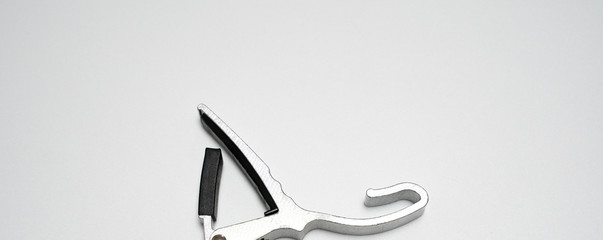 silver and black Guitar clip isolated in white background