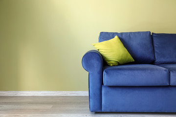 Comfortable sofa near color wall