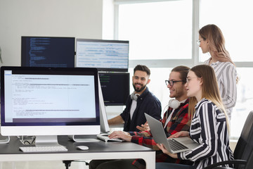 Team of programmers working in office