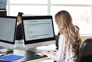 Fototapeta na wymiar Female programmer working in office