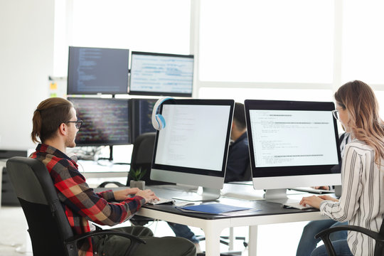 Team of programmers working in office