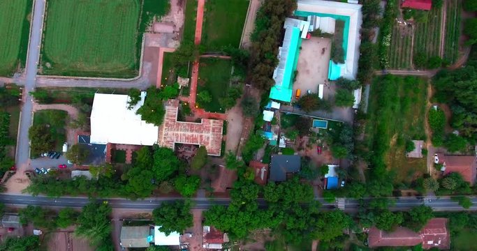 Lush green Calera de Tango rural commune farmhouse of Chile outskirts, drone shot