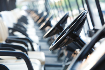 Golf cars or golf carts in a row outdoors on a sunny spring day