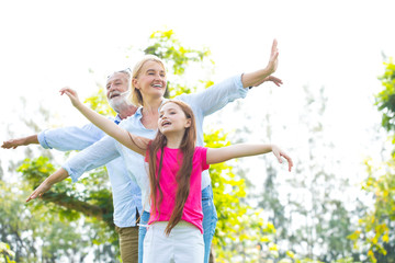 Happy Old Grandparents Having Fun With Grandchildren In Park