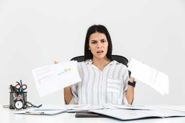 Photo of tense brunette businesswoman 30s screaming and stressing while working with paper...