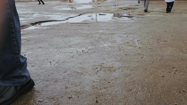 Puddles on broken road and asphalt with pits. ars driving on bad road surface