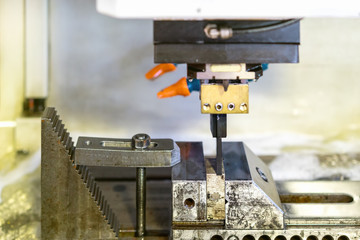 close up workpiece and graphite electrode during working on automatic electrical discharge machine (edm)