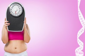 Fat female belly and scale on background