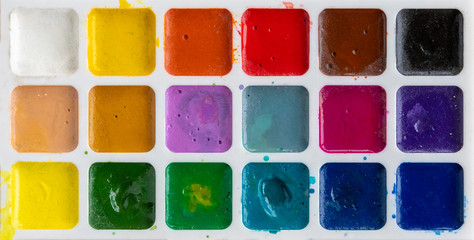 Bright, colorful watercolor paints for creativity, a set of 18 colors, closeup.