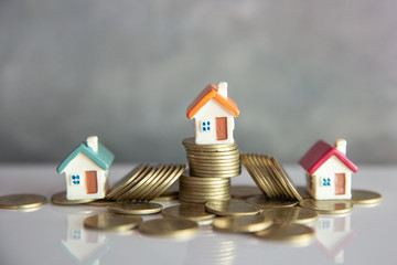 Mini house on stack of coins,Money and house,  Mortgage, Savings money for buy house and loan to...
