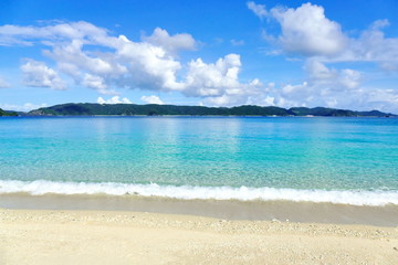 Fototapeta na wymiar Tropical paradise of white sand, turquoise sea and deep blue sunny sky at Zamami, Okinawa, Japan
