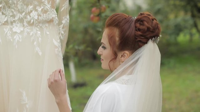 Beautiful and lovely bride in night gown and veil. Wedding dress. Slow motion