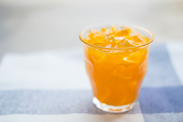 Glass of fresh orange juice with ice cubes