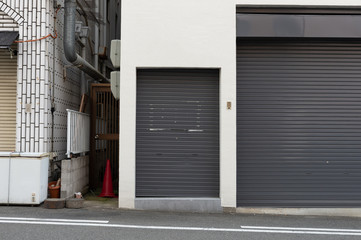 A closeup shot of automatic metal roller door used in factory, storage, garage, and industrial warehouse. The corrugated and foldable metal sheet offer space saving and provide urban and rustic feel