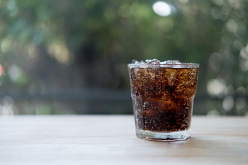 Refreshing black soda soft drinks with ice in a clear glass