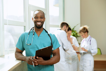 Healthcare people group. Professional african american male doctor posing at hospital office or...