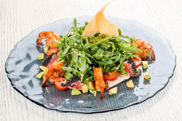 Salad with tiger shrimps, arugula, avocado and grapefruit under oyster sauce