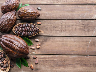 Cocoa pod and cocoa beans on the wooden table. Top view.