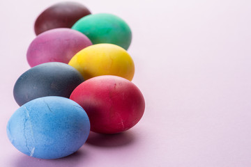 Colorful Easter eggs as an attribute of Easter celebration. Pink background.